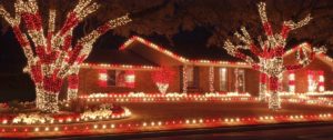 A home decorated with a white and red lights resembling candy canes in the middle of the night.