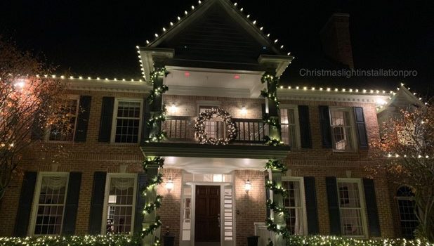 suburban home decorated with Christmas lights